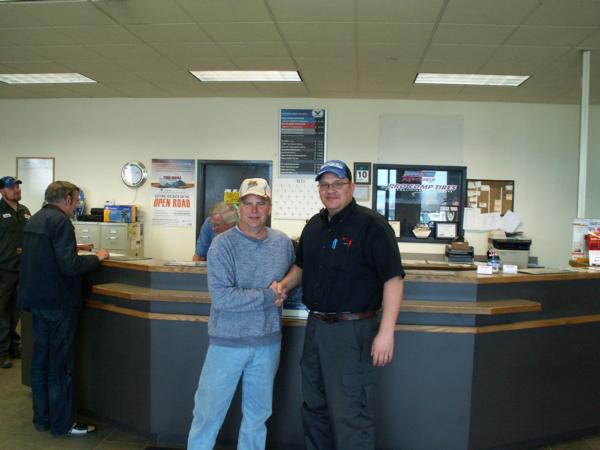 Randy Piearson, President of the Headwaters Chapter thanks Neil Perry, manager of the Tire Rama Store in Helena for their on-going support of Pheasants Forever.